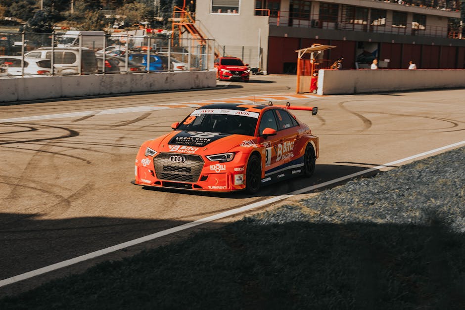 Orange performance racing car on a track representing speed